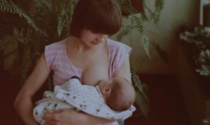 young mother breastfeeding her baby