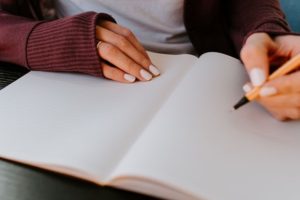 hs patient taking notes when talking to her dermatologist