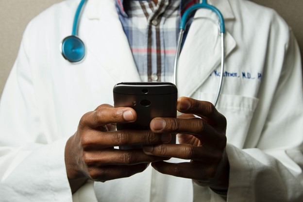 Dermatologist holding a smartphone